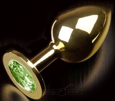Золотистая анальная пробка с салатовым кристаллом - 9 см. - фото, цены